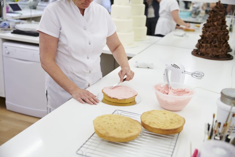 woman-in-bakery-decorating-cake-with-icing.jpg